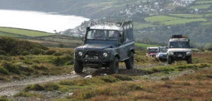 multiple 4 by 4 vehicles on a green lane above Laxey.